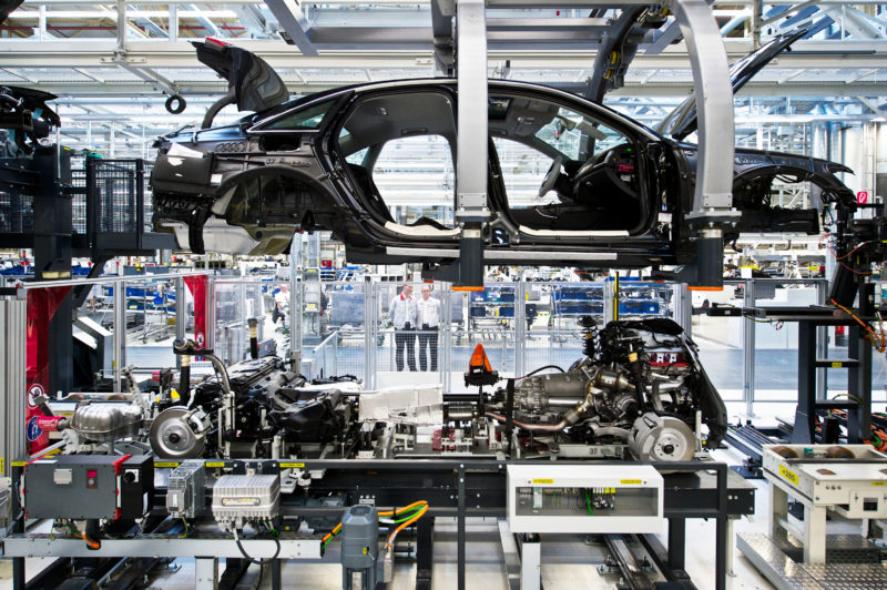 Industrial Photography: At the wedding on the assembly line in the automotive manufacturing the engine is placed into the body.