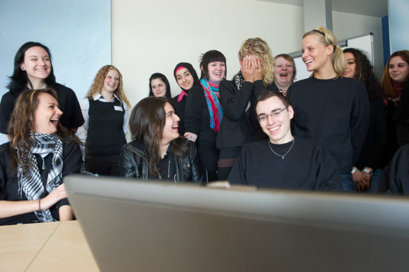 Editorial photography: In commercial training, female trainees dominate. In a group the only man sits in the middle and everyone is happy.