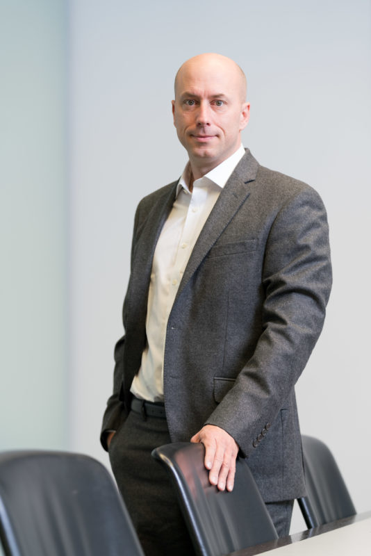 Business portrait: Portrait photo of a manager. A large conference room is a suitable place for many different portraits in a short time.