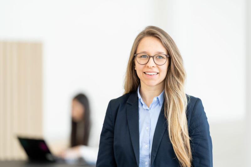 Business portrait: Employee portrait photographed in series. The background changes with every picture but yet appears as a series. Picture 07 of 35