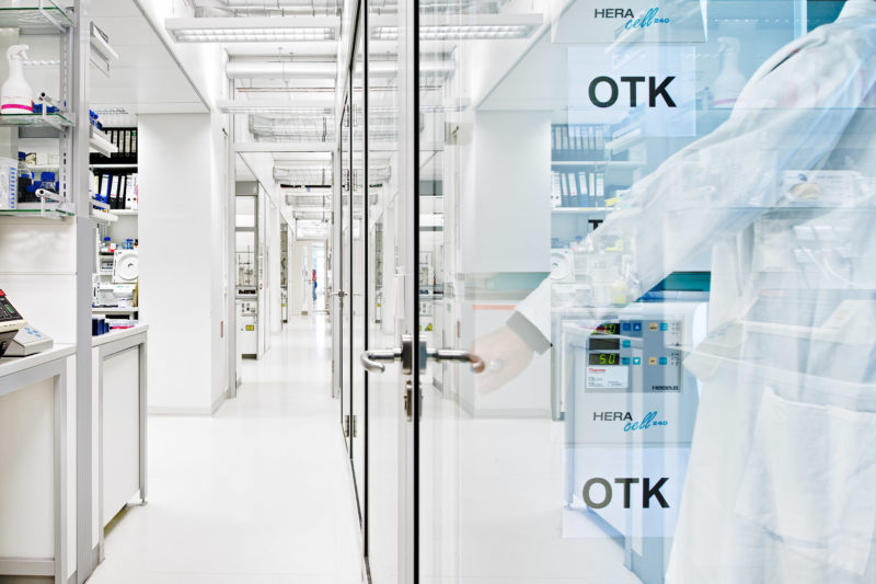 Science photography: Employee enters a work cell at the Floor of a clean room laboratory German Cancer Research Center in Heidelberg.