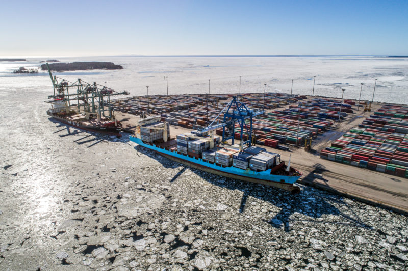 Aerial and Drone photography: A Finnish container port which is almost completely surrounded by ice floes.