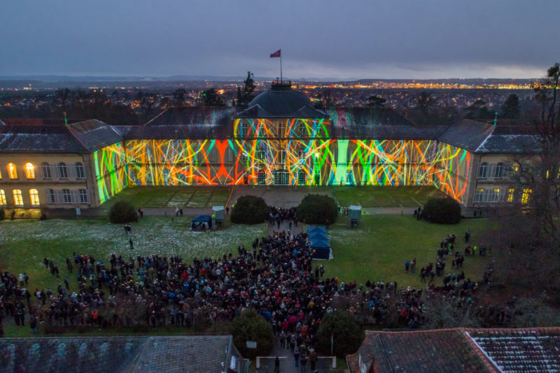 Aerial and Drone photography: Kick-off event for the 200th anniversary of the University of Hohenheim: Night-time shot of the light show on the facade of the Palace.