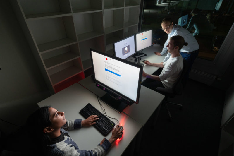 Editorial Photography: Scientist researches the interface between man and machine and the visual interaction required for this. A view into a room with displays and a device that follows the line of sight on the monitor.