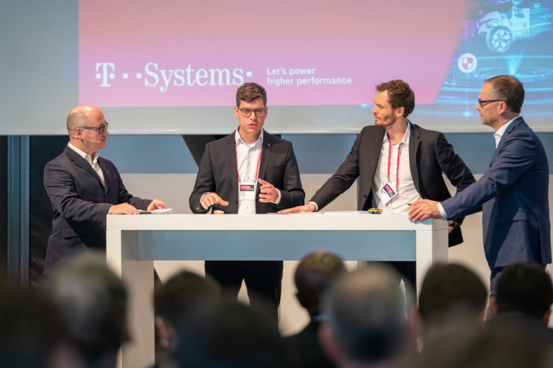 Event photography: A customer event of an IT company: panel discussion with spectators in the foreground.