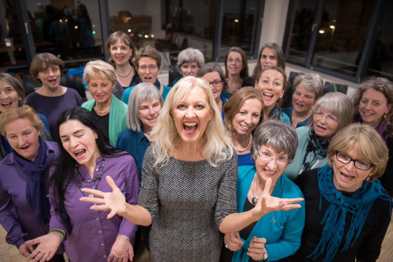 Employees photography: A singer at rehearsal with her colleagues from a recreational choir. The picture sharpness lies on the face of the singer in the middle.