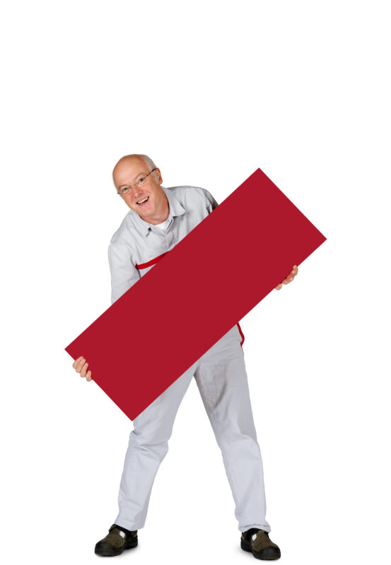 Employees photography: For a personnel campaign of a vehicle manufacturer, employees pose with a red sign against a white background. The photos are full body shots and each person acts differently in front of the camera. Here an employee holds his sign diagonally into the picture with his legs apart.