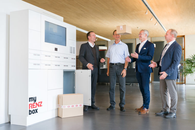 Group photo: Project members stand by their finished product, a mailbox-like, networked storage box for parcels. They