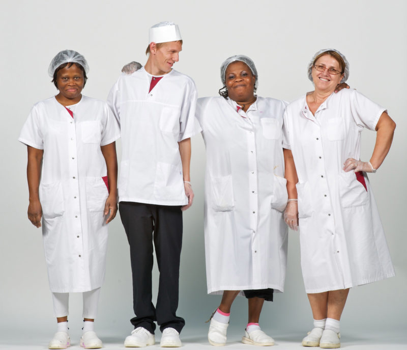 Group photo: Groupshot: House cleaners on a white background dressed in white.