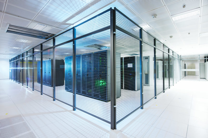 Industrial photography: In separate compartments secured with a grid are the hosted servers in a data center.