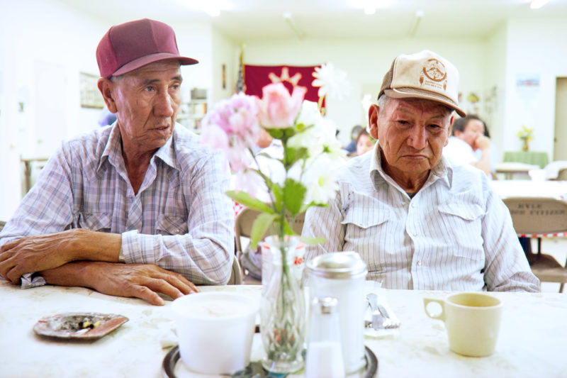 Reportage photography on slide film in the Pine Ridge Reservation in South Dakota, USA: In the community centre in one of the settlements older tribal members are served lunch and coffee.