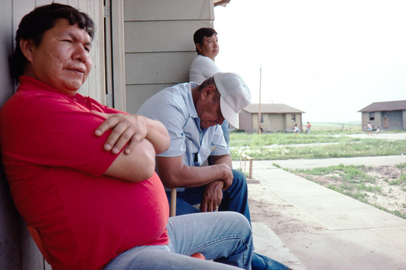 Reportage photography on slide film in the Pine Ridge Reservation in South Dakota, USA: For many men in the settlements of the reservation, everyday life consists of sitting and doing nothing.