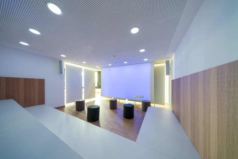 Architectural photography:  In a modern office building, there are interestingly designed rooms that are designed to promote creativity and communication. Here is a corner equipped with seats and stools, which was separated from the passage behind by movable walls.