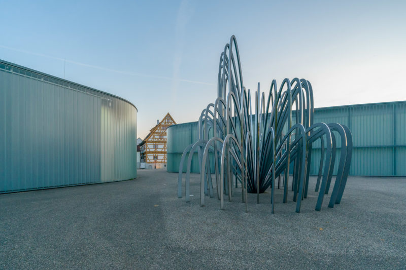 Landscape photogaphy:  A typical city view of Waiblingen: The Stihl-Galerie with a sculpture by the Danish artist Olafur Eliasson in front of it. In the background one of the many half-timbered houses of the old town.