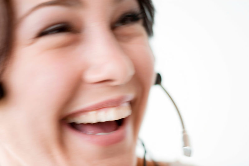 Industrial photography: A woman in a call center with a headset.