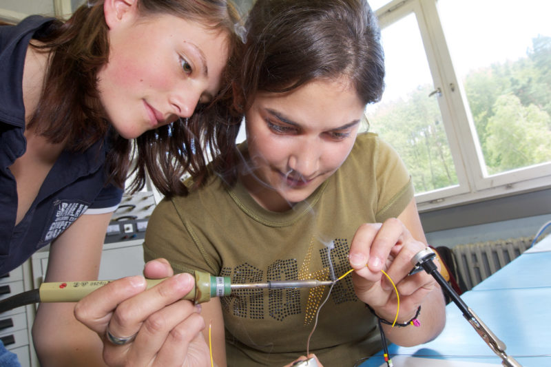 Editorial photography: At the Pupils Engineering Academy two girls are learning how to solder.