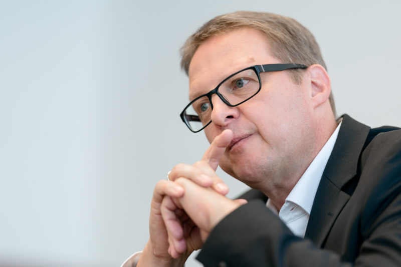 Portrait photography - Portrait of a manager of a large software company: Portrait of a thoughtful man taken with a long focal length.