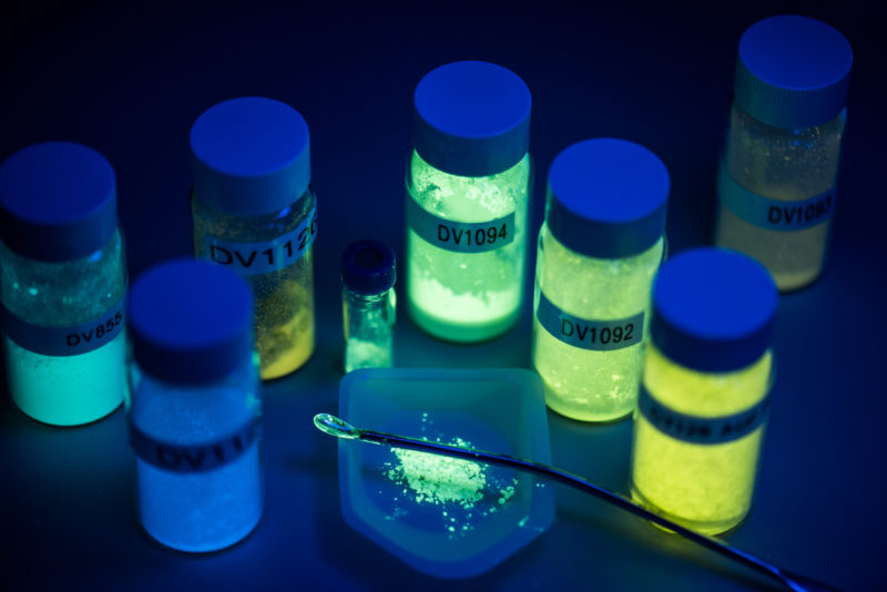 Science photography:  Samples glowing in the dark for research on substances for OLEDs with copper complexes.