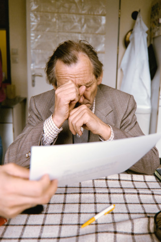 editorial photography at a psychiatric ward: A male patient is presented with a declaration of consent for his treatment on the closed ward.