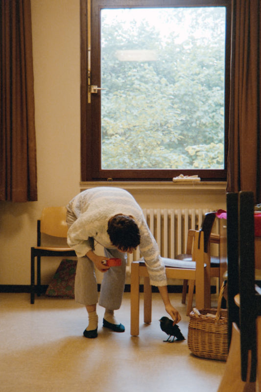 editorial photography at a psychiatric ward: A patient brought a sick bird to her room in the closed ward. A little later it dies.