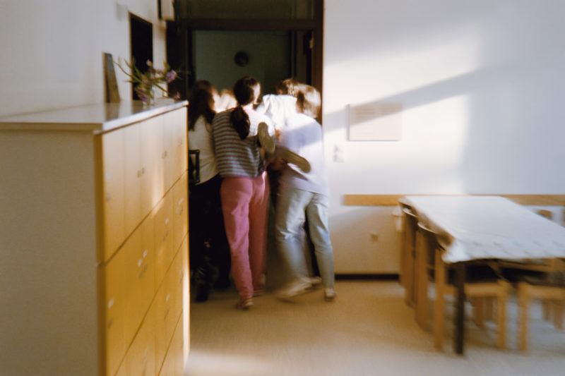 editorial photography at a psychiatric ward: Several nurses carry a patient of the closed ward to her room after she has attacked people.