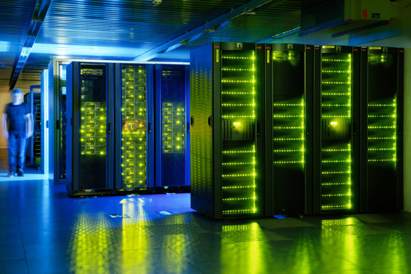 Industrial photography: Green illuminated computer racks in a data center or computer center.