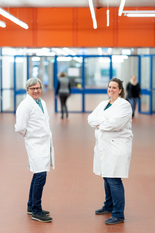 Reportage photography: Scientists create artificial ivory: they stand in white lab coats in the hallway of the institute and rejoice.