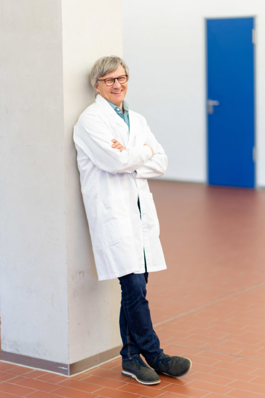 Reportage photography: Scientists create artificial ivory: Single portrait of the male scientist in a white lab coat.