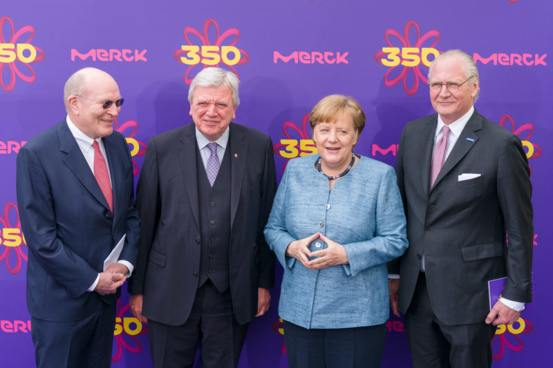 editorial photography: German Chancellor Angela Merkel at the celebration of the 350th anniversary of Merck in Darmstadt. The hosts and Hessian Prime Minister Volker Bouffier at the group photo against the VIP photo background.