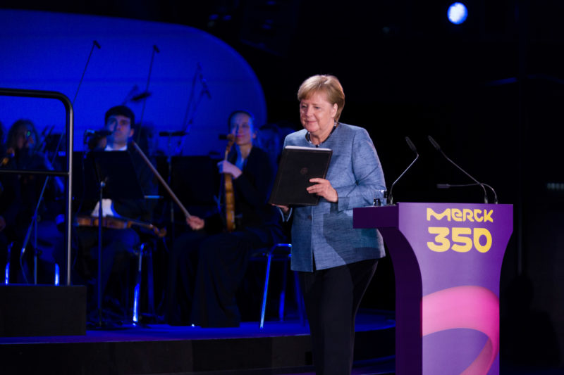 editorial photography: German Chancellor Angela Merkel at the celebration of the 350th anniversary of Merck in Darmstadt. After her speech she leaves the podium.