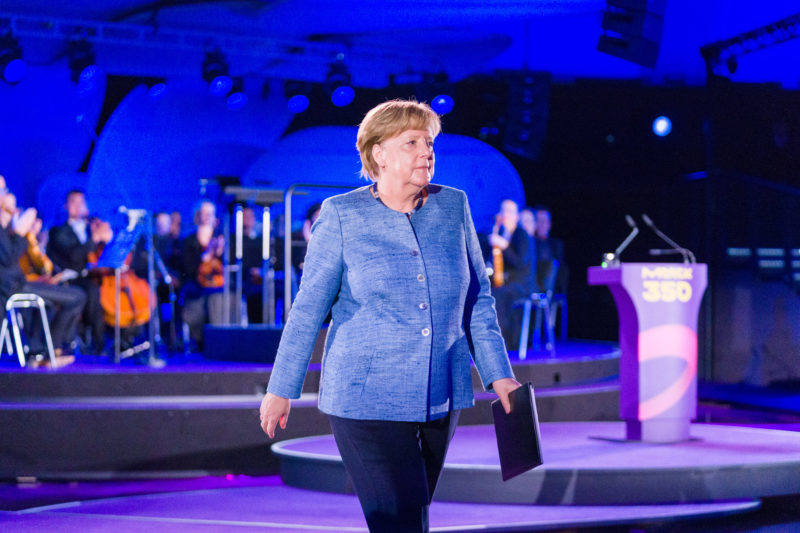 editorial photography: editorial photography: German Chancellor Angela Merkel at the celebration of the 350th anniversary of Merck in Darmstadt. After her speech, she returns to her seat in the audience.