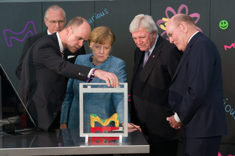 editorial photography: German Chancellor Angela Merkel at the celebration of the 350th anniversary of Merck in Darmstadt during a technical demonstration.