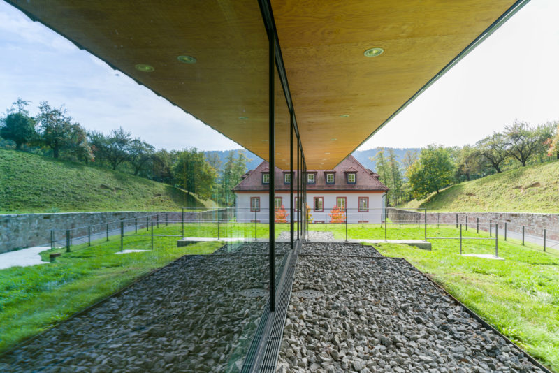 Architectural photography: At a private college, one of the historic buildings is reflected in the new glass facade of the auditorium.