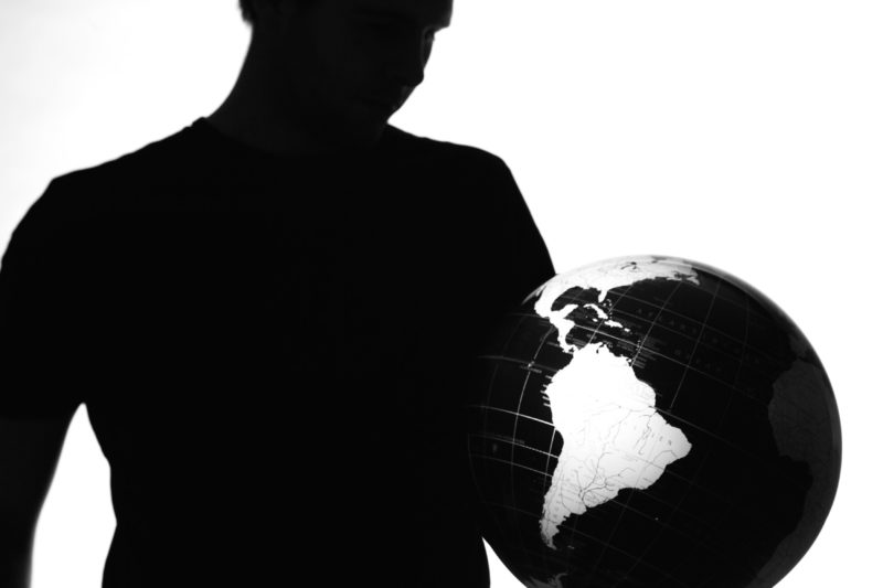 Studio photography: Silhouette of a man holding a globe.