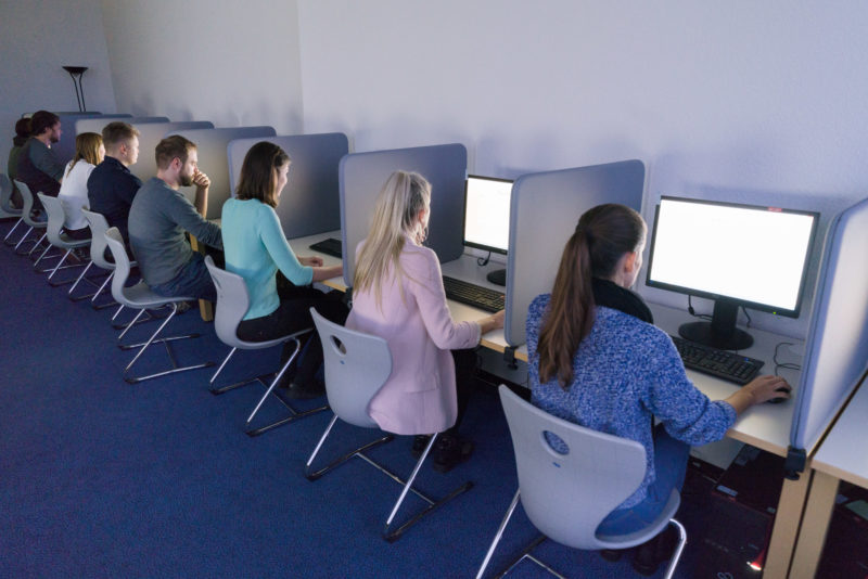 Editorial photography, subject learning and education:  In a test room at the Institute for Economic and Social Sciences and Media Psychology at the University of Hohenheim, test persons work their way through a computer-analysed survey as part of a study.