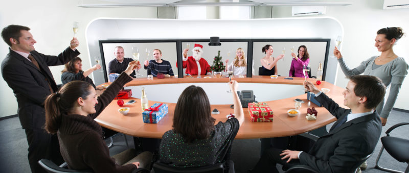 Photomontage with Photoshop: A collage for the Christmas post: employees sit in the video conference room and toast the New Year with their colleagues on their screens