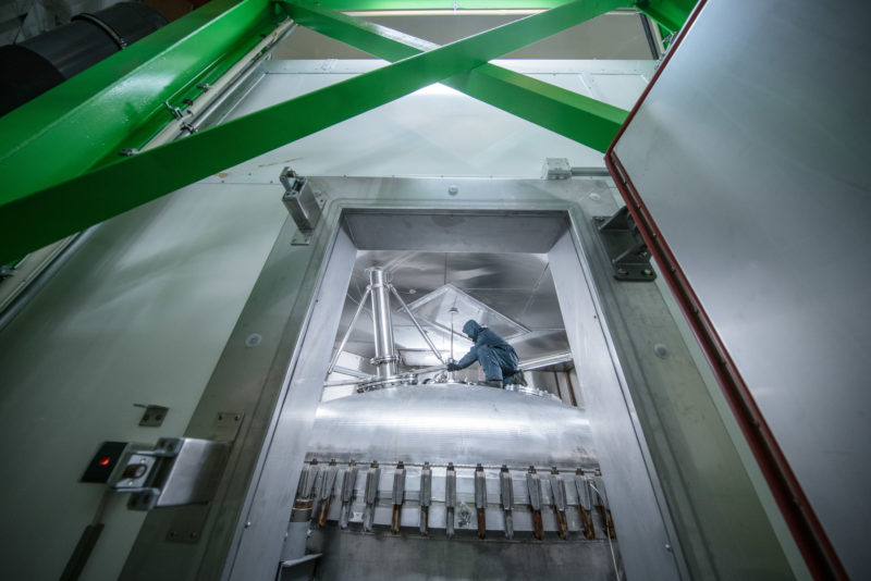 Science photography: An employee works in a cold suit on the upper dome of the cloud chamber AIDA at the Institute of Meteorology and Climate Research (IMK) of the Karlsruhe Institute of Technology (KIT). In the cloud chamber the temperatures, the humidity and the pressure of the cloud forming air layers of the earth can be simulated.