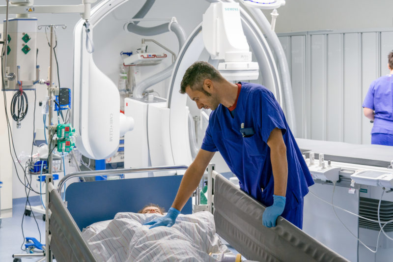 Healthcare photography: Doctor and his little patient In the cardiac catheter laboratory of the pediatric cardiology department of the University Hospital Homburg (Saar).