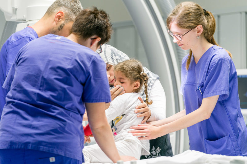 Healthcare photography:  A mother comforts her girl before an operation in the cardiac catheter laboratory of the pediatric cardiology department of the University Hospital Homburg (Saar).