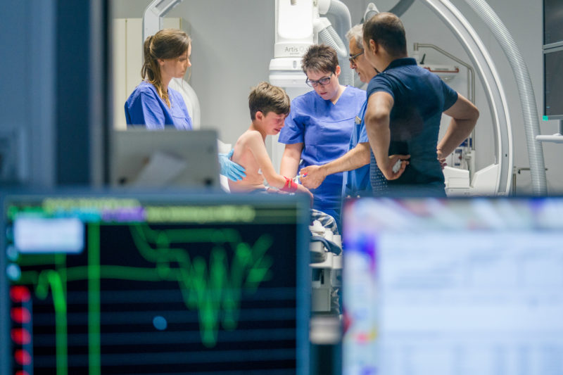 Healthcare photography: In the cardiac catheter laboratory of the pediatric cardiology department of the University Hospital Homburg (Saar) a boy cries when he is prepared for surgery.